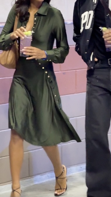 Olive green silk shirt dress with gold buttons, paired with black strappy heels and a brown bag.