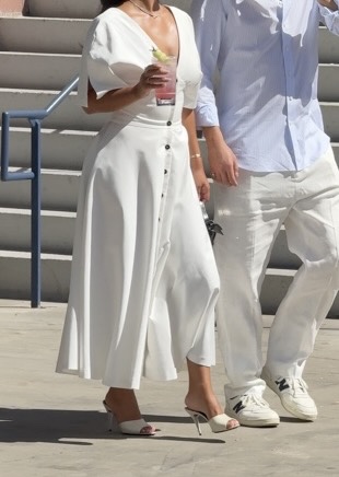 White V-neck maxi dress with puff sleeves, button front, and white mule heels.